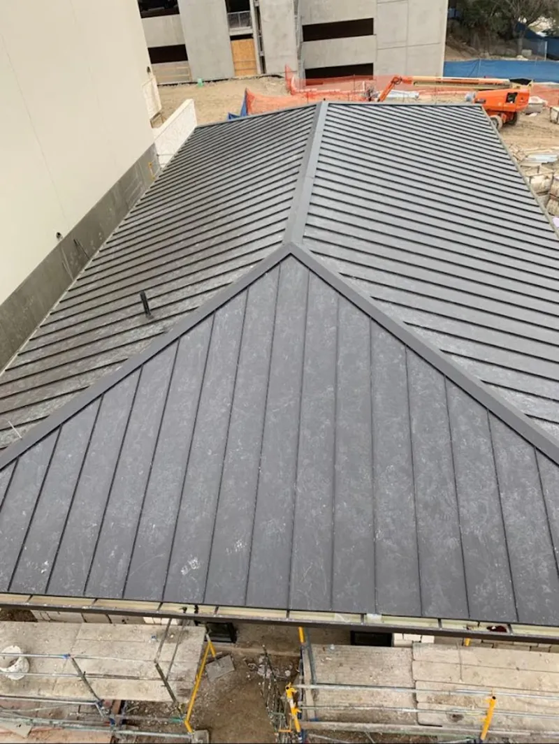 Commercial metal roof construction with crane equipment in Archbald